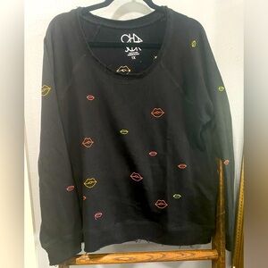Brand new without tags size 1X chaser sweater.  Black with embroidered lips!